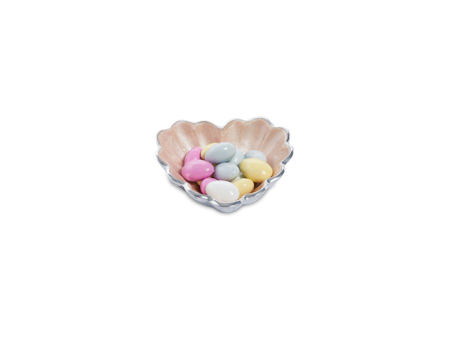 small pink heart bowl holding candies