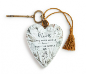 white floral ornamental heart with gold tassel and key