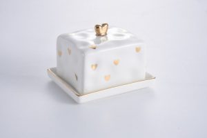 White butter dish with small gold heart pattern